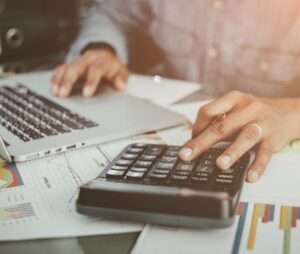 Financial Calculation with Laptop and Calculator